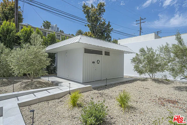 a white house with a large tree in front of it