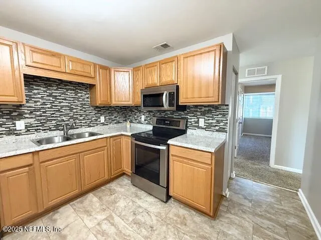 a kitchen with granite countertop a sink cabinets and window