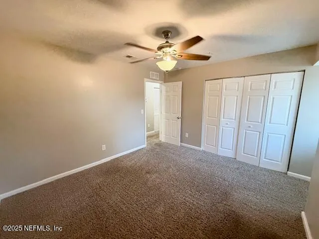 an empty room with a empty space and a ceiling fan