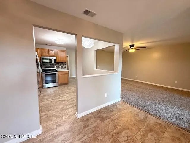 wooden floor in an empty room and a kitchen