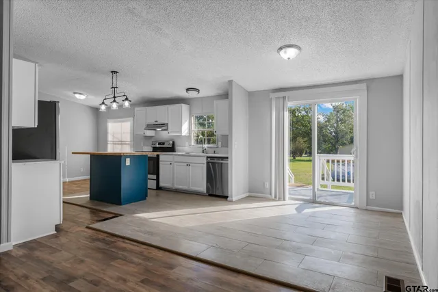 a view of a kitchen with a sink and a living room