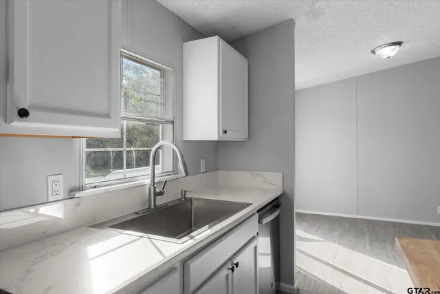 a kitchen with a sink and a window