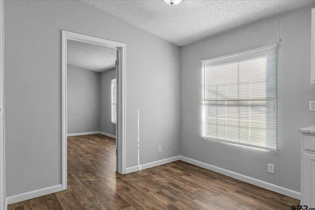 an empty room with windows and closet