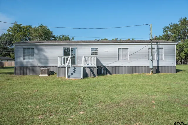 a view of a house with a yard and table