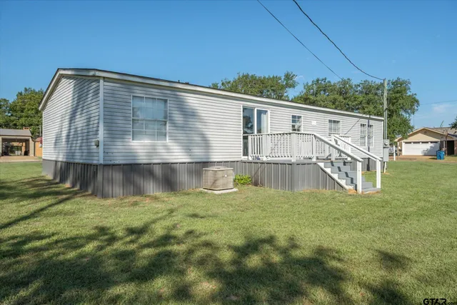 a view of house with backyard