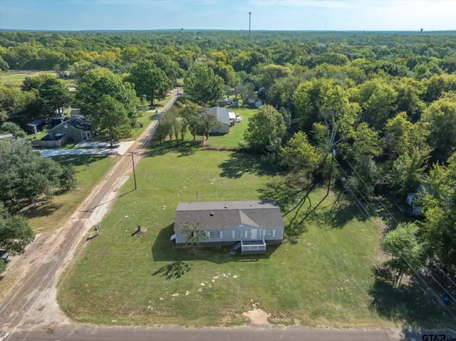 an aerial view of a house with a yard