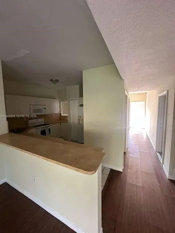 a kitchen with a refrigerator and a sink