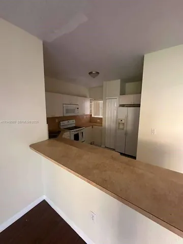a view of a kitchen with a sink