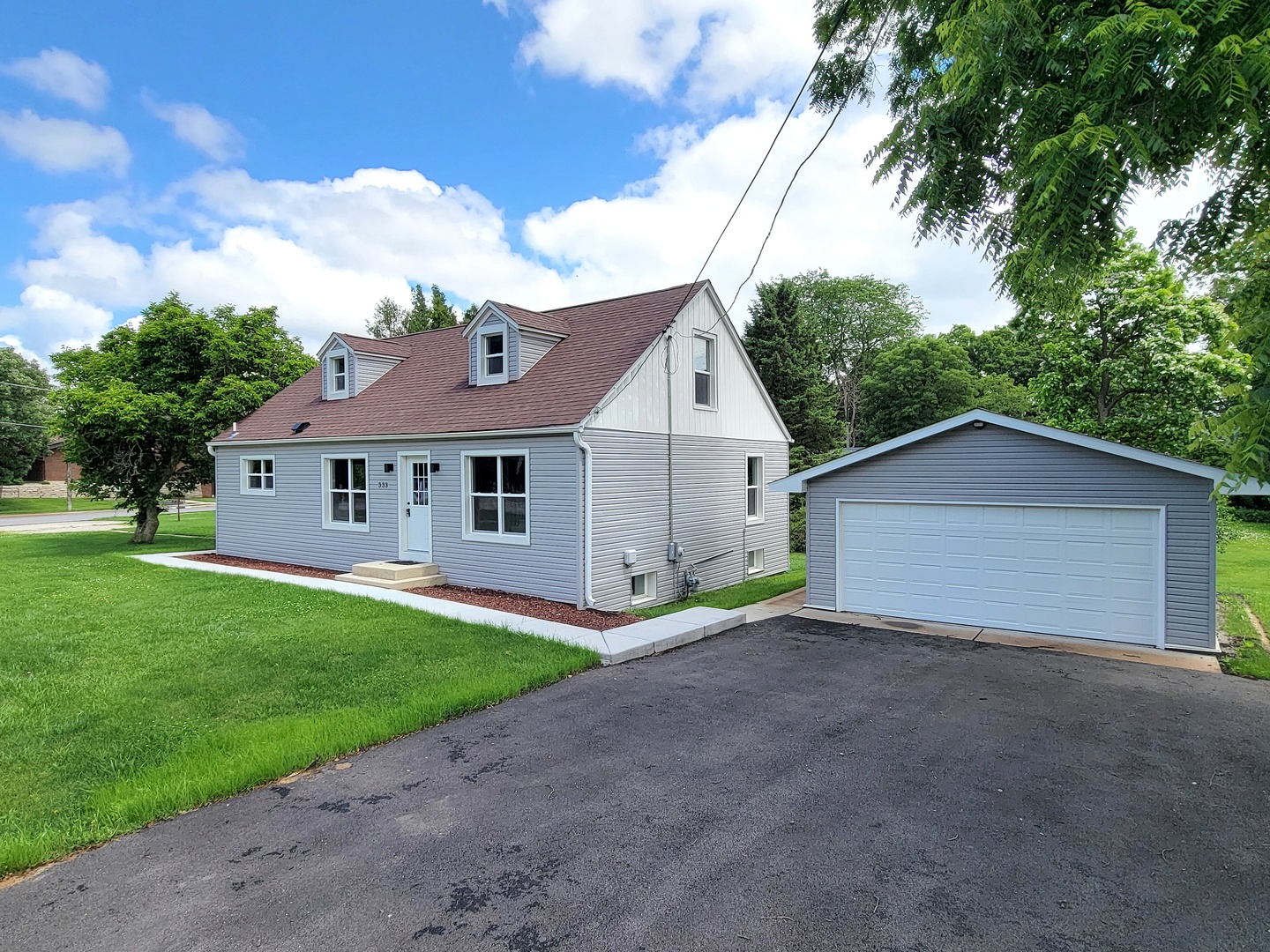 S333 Winfield Road Winfield, IL 60190 - Photo 1 of 37 a front view of a house with a yard and garage