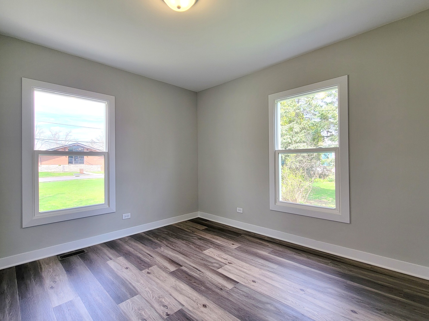 S333 Winfield Road Winfield, IL 60190 - Photo 19 of 37 a view of an empty room with wooden floor and a window