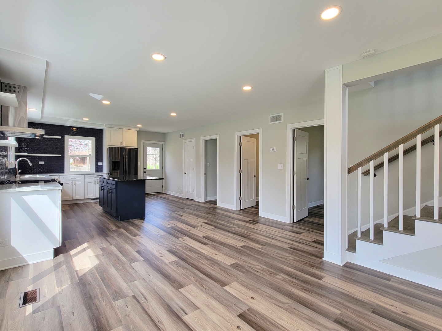 S333 Winfield Road Winfield, IL 60190 - Photo 2 of 37 a view of an empty room with wooden floor and a kitchen