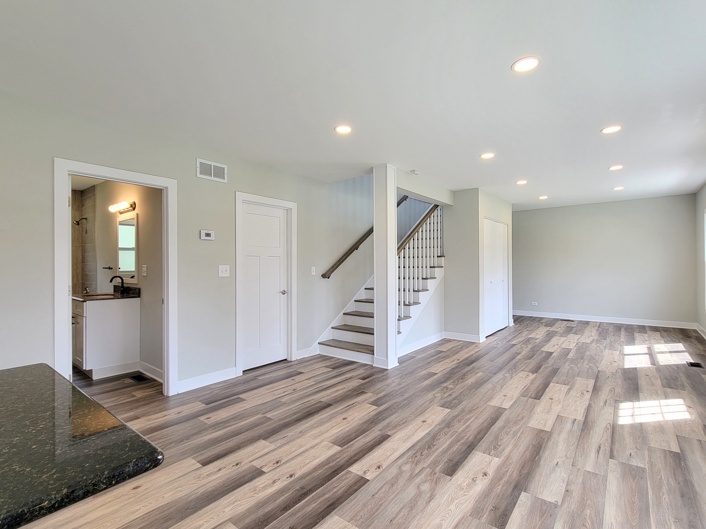 S333 Winfield Road Winfield, IL 60190 - Photo 8 of 37 a view of a livingroom with wooden floor and stairs