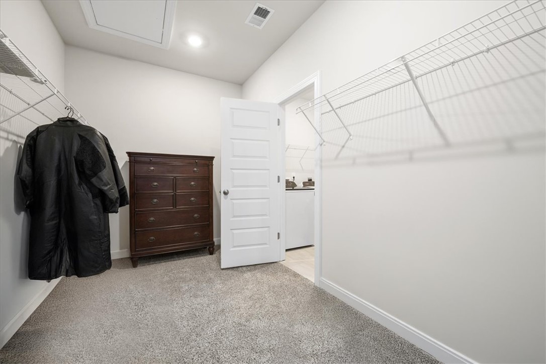 106 Purcell Way Easley, SC 29642 - Photo 25 of 39 This ample walk-in closet offers extensive storage and seamless access to the laundry area.
