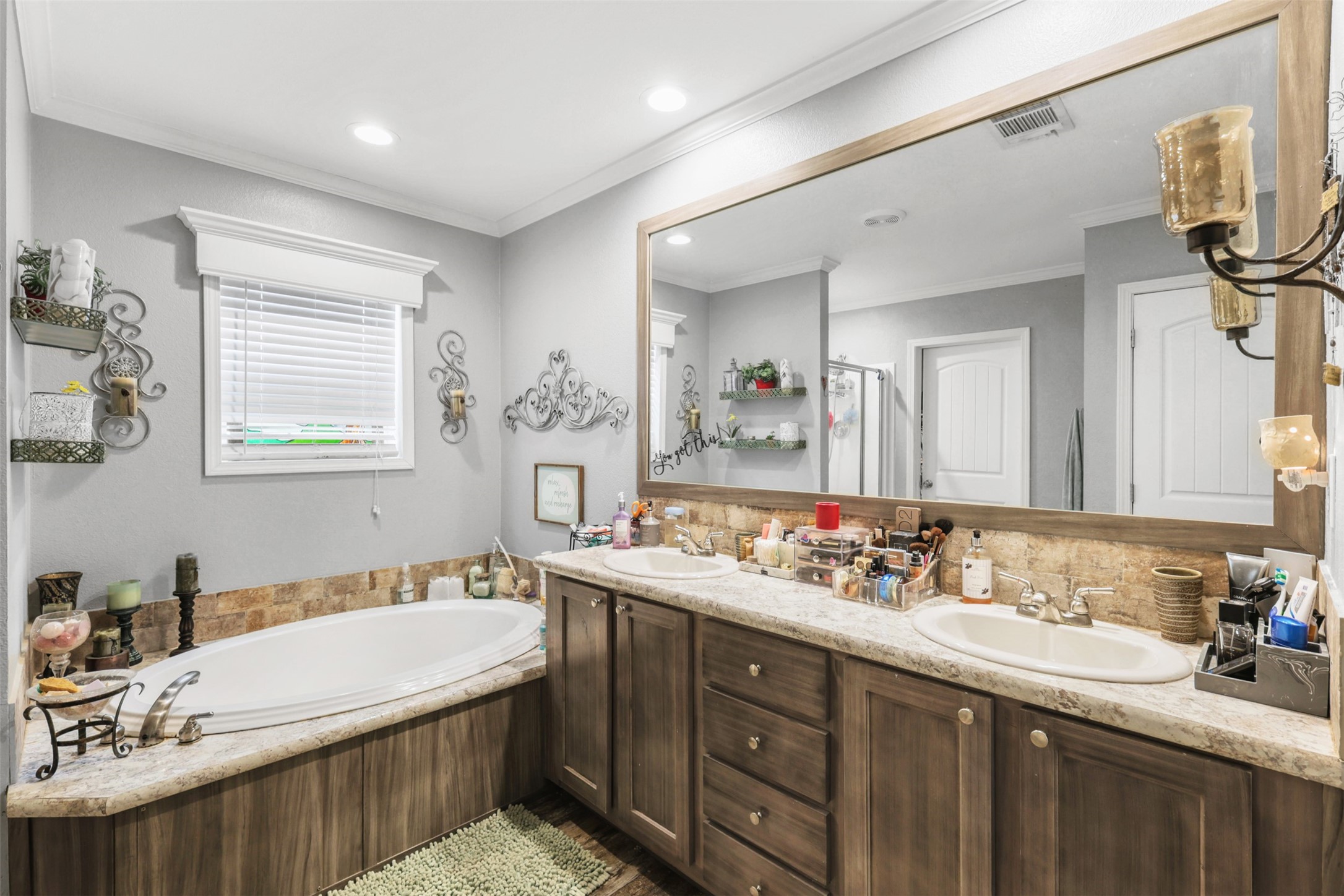 735 Boysenberry Road Somerville, TX 77879 - Photo 12 of 36 a bathroom with a sink double vanity granite tub shower and a mirror