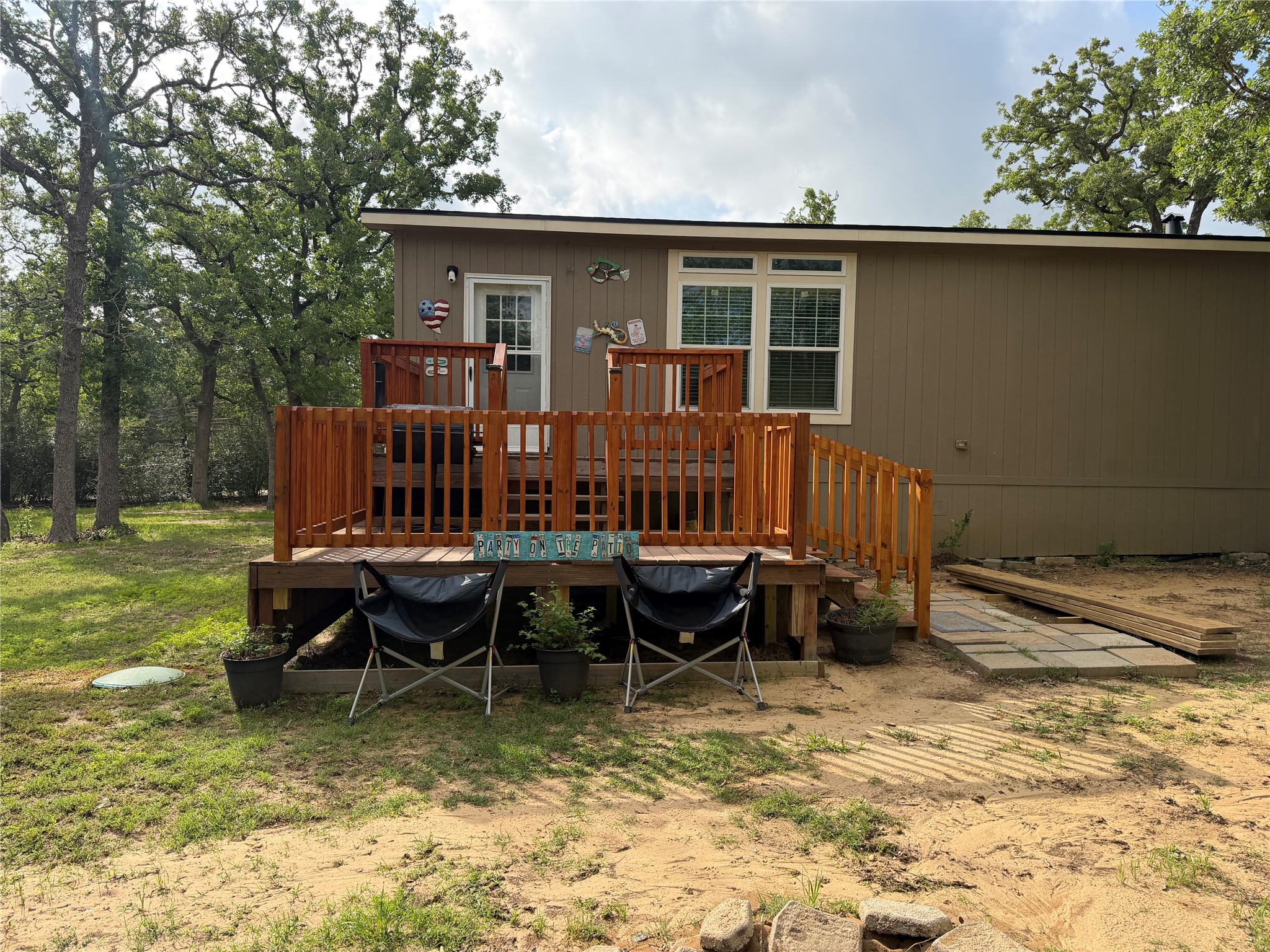 735 Boysenberry Road Somerville, TX 77879 - Photo 35 of 36 a view of a house with backyard wooden fence and sitting area