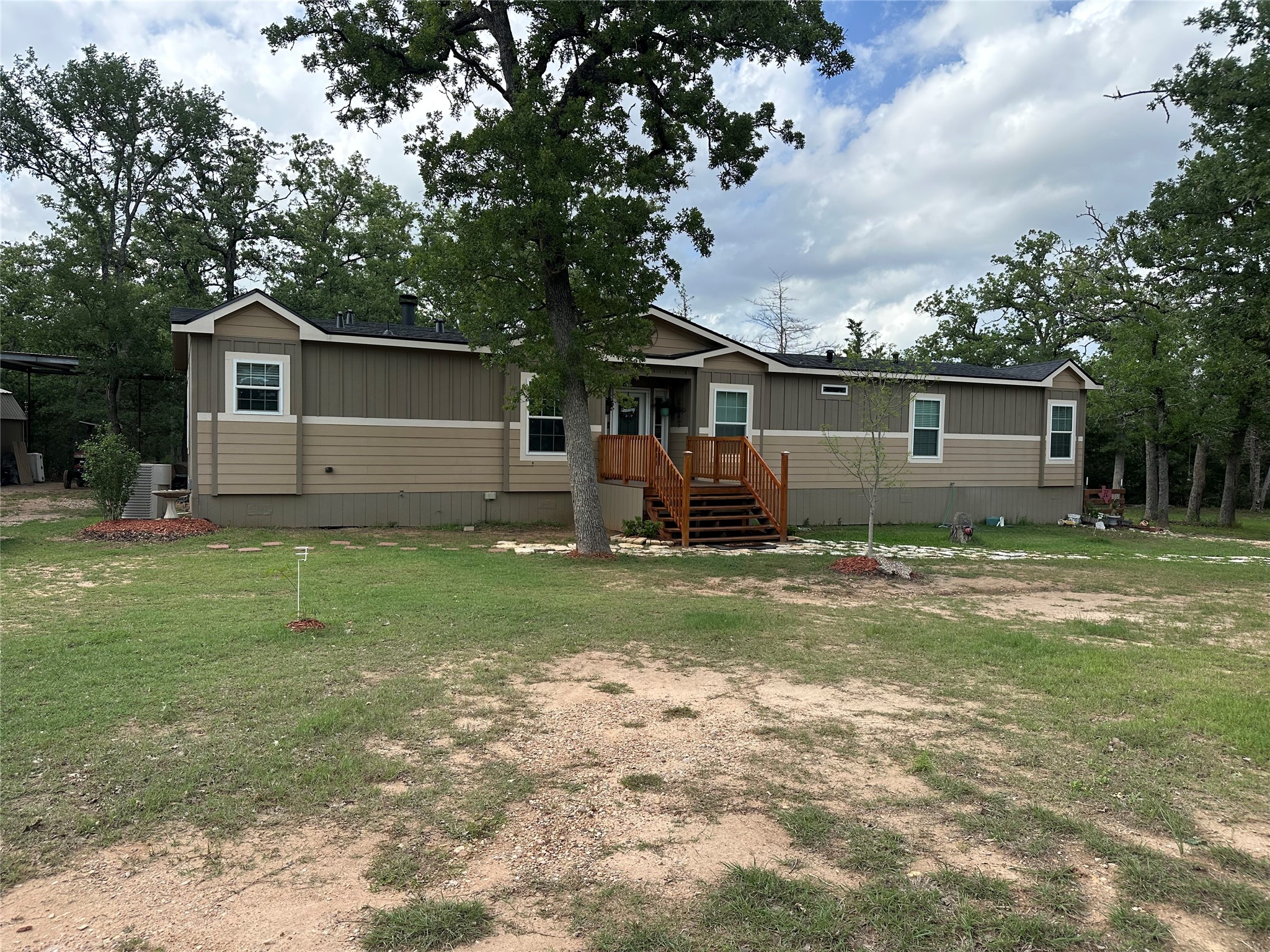 735 Boysenberry Road Somerville, TX 77879 - Photo 5 of 36 a front view of house with yard and green space