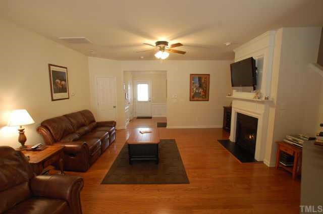 7038 Racine Way Raleigh, NC 27615 - Photo 7 of 12 Living room has gas log fireplace with built in wiring for the flat screen. (tv does not convey) Other