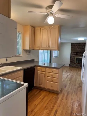 a kitchen with granite countertop a sink stainless steel appliances and cabinets