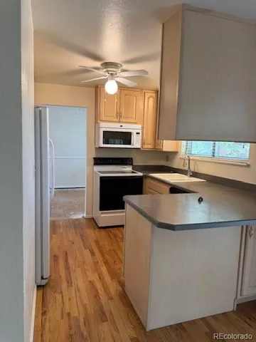 a kitchen with kitchen island stainless steel appliances a sink and a counter top space