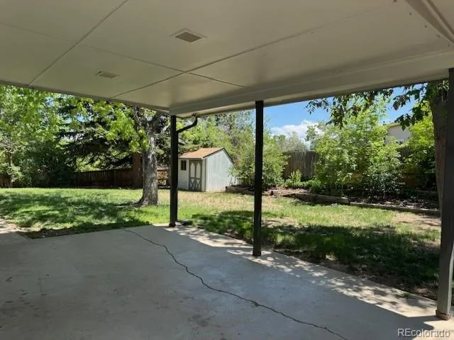 a view of a road with porch and a big yard