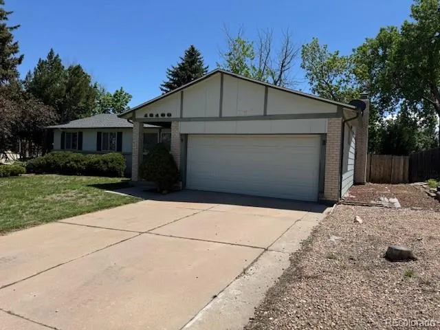 a front view of house with yard garage and green space