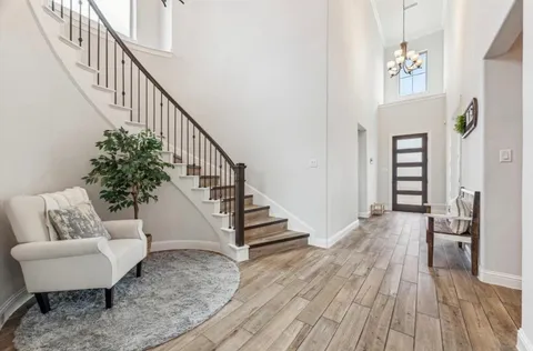 a view of entryway and hall with wooden floor