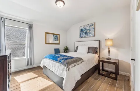a bathroom with a double vanity sink toilet and shower
