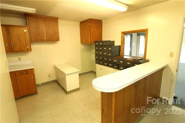 a kitchen with sink and refrigerator