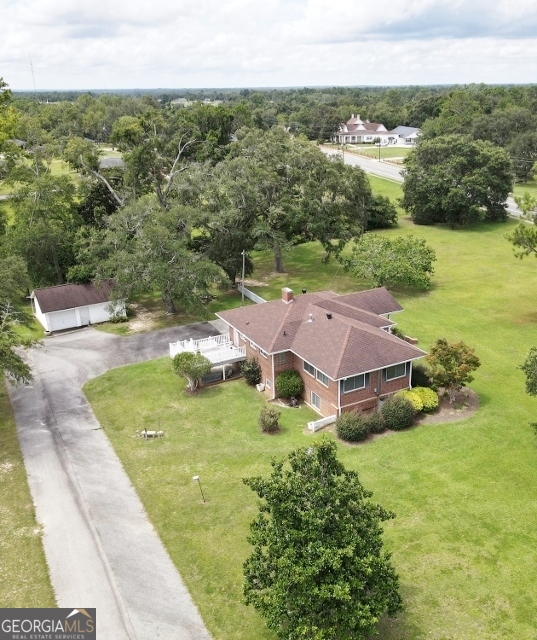 7586 Eastman Road Soperton, GA 30457 - Photo 21 of 29 an aerial view of residential houses with outdoor space and trees
