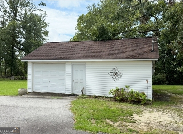 7586 Eastman Road Soperton, GA 30457 - Photo 26 of 29 a front view of a house with a garden