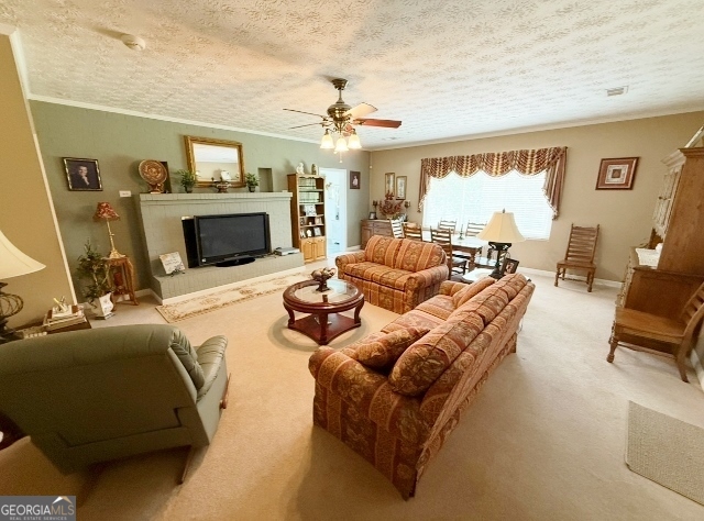 7586 Eastman Road Soperton, GA 30457 - Photo 4 of 29 a living room with furniture a fireplace and a flat screen tv