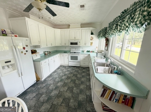7586 Eastman Road Soperton, GA 30457 - Photo 8 of 29 a kitchen with granite countertop a sink a counter space appliances and cabinets