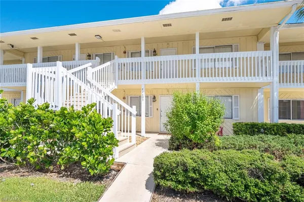 a view of a house with balcony and garden