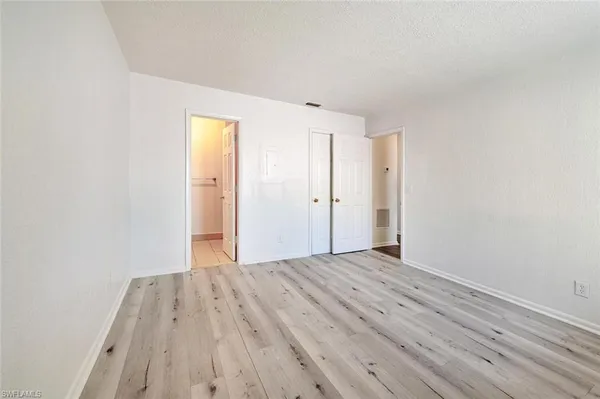 a view of a room with wooden floor