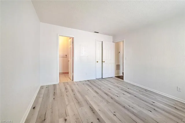a view of a room with wooden floor