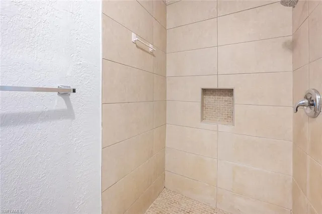 an empty room with wooden floor and a hallway