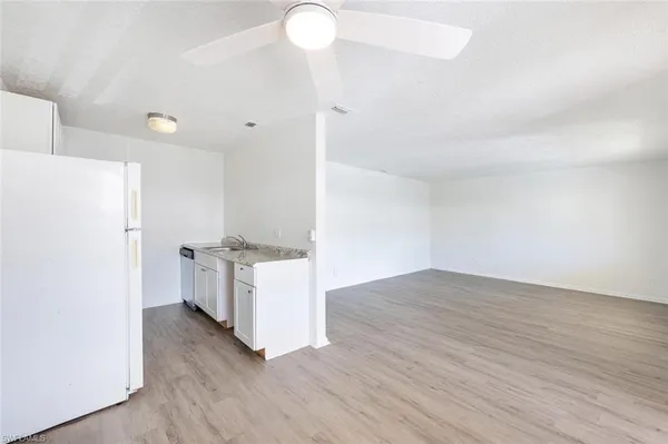 a view of a kitchen with wooden floor