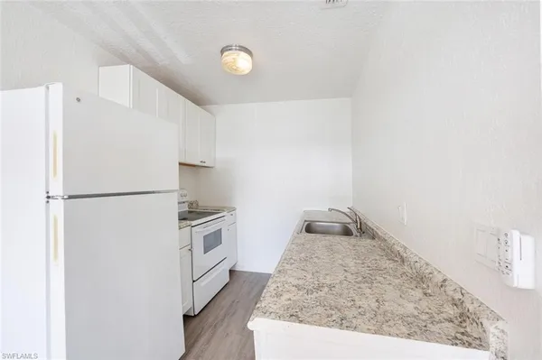 a kitchen with a stove and a refrigerator