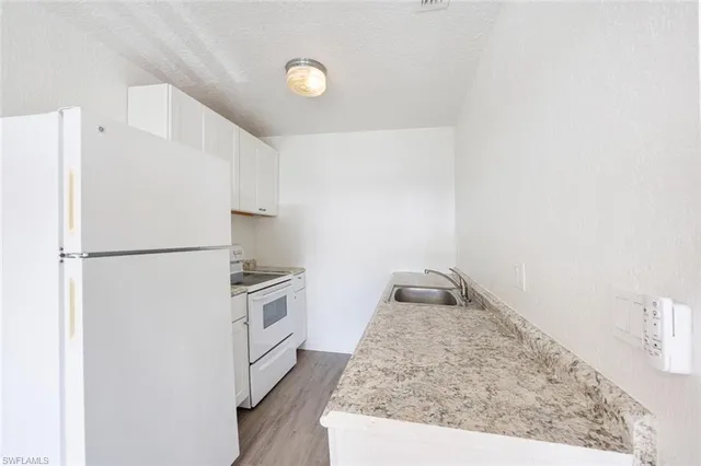 a kitchen with a stove and a refrigerator
