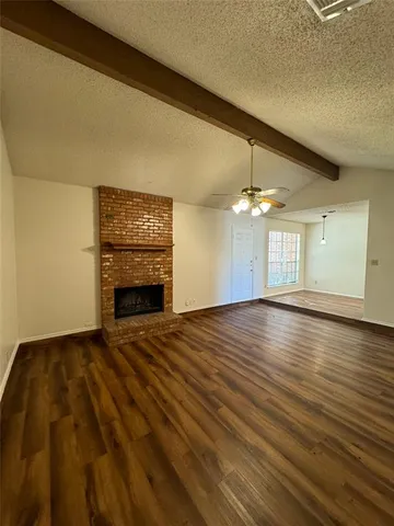wooden floor in an empty room with a fireplace