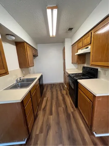 a kitchen that has a sink and a stove in it