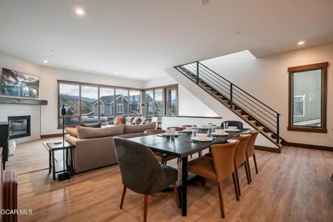 a dining room with furniture window and wooden floor