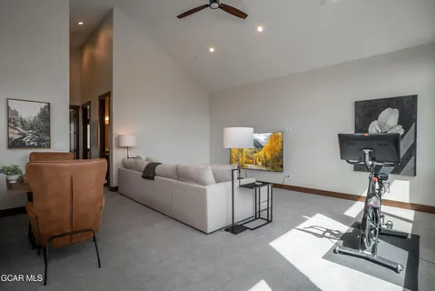 a living room with furniture and a chandelier