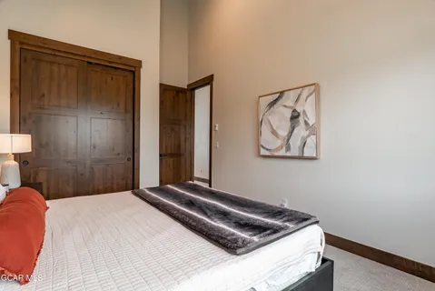 a bedroom with a bed and painting on the wall