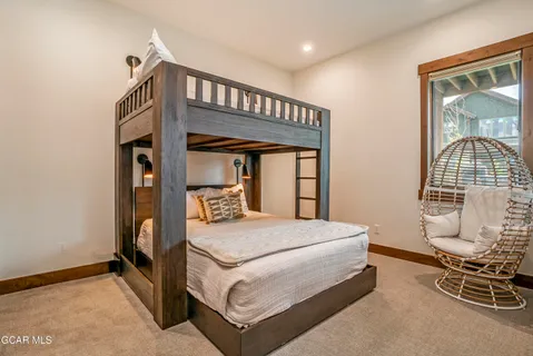 a bedroom with a bed a table and chair