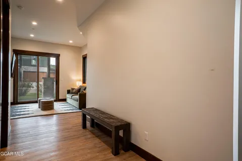 a view of a room with gym equipment and wooden floor