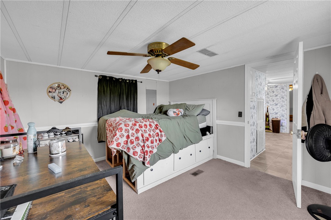 150 Newberry Road Walhalla, SC 29691 - Photo 16 of 47 A comfortable bedroom featuring soft carpet flooring and a practical ceiling fan for year-round comfort.