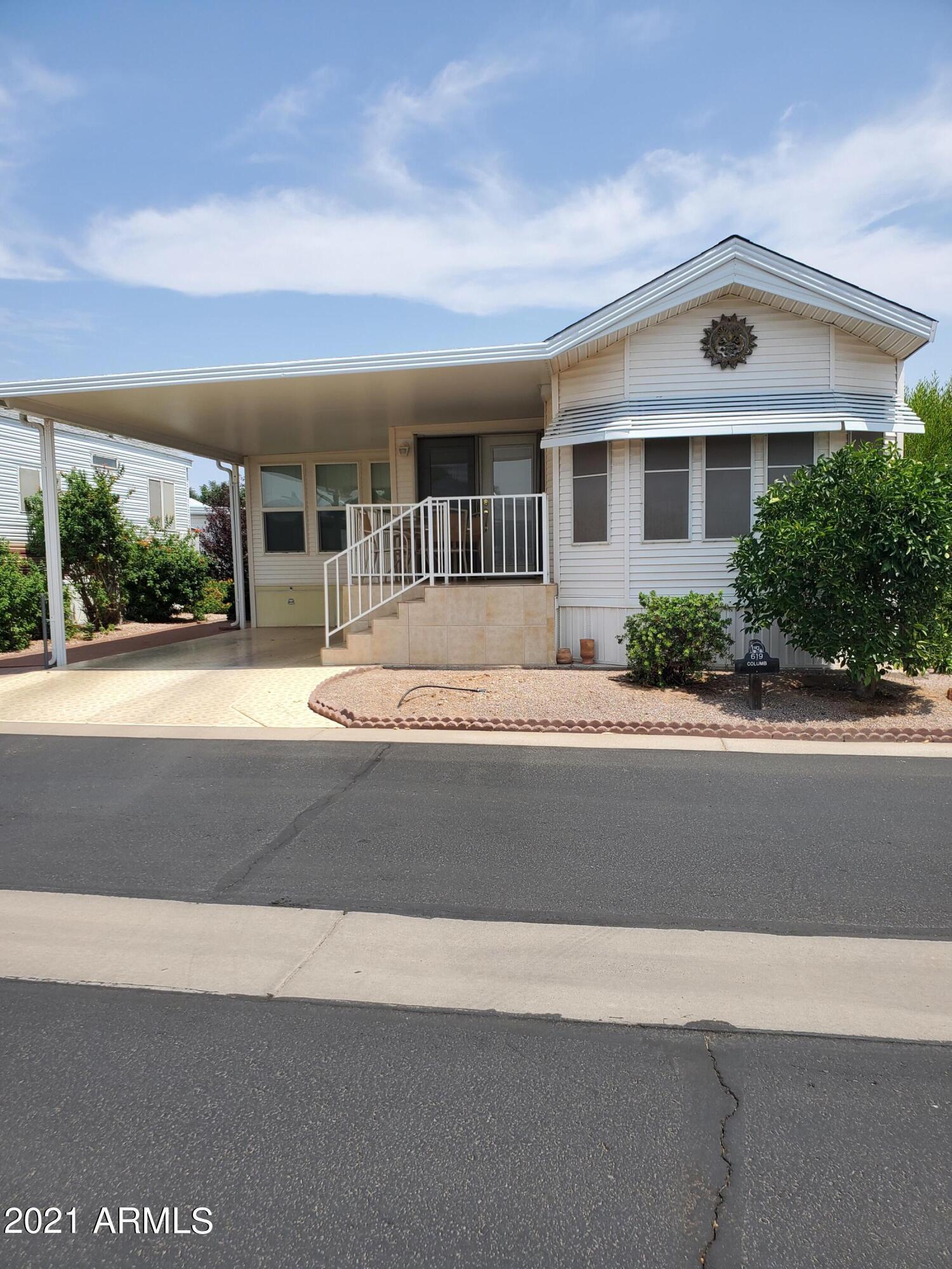 7750 East Broadway Road, Unit LOT 619 Mesa, AZ 85208 - Photo 1 of 33 a front view of house with yard and green space
