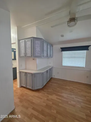 a view of a kitchen with wooden cabinet