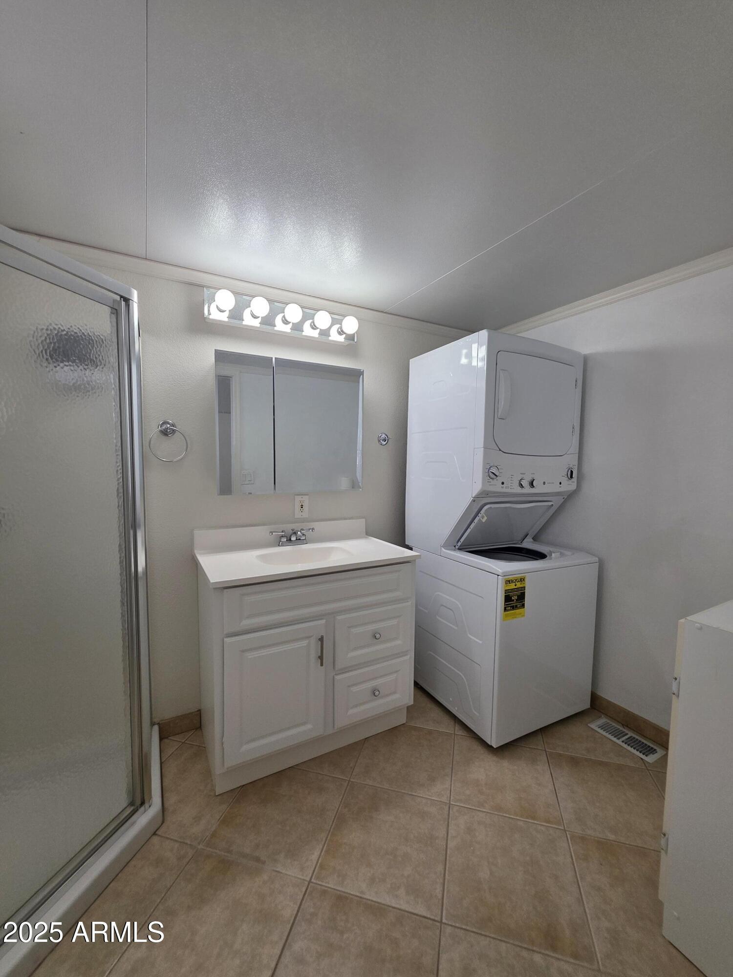 7750 East Broadway Road, Unit LOT 619 Mesa, AZ 85208 - Photo 6 of 33 a bathroom with a sink a vanity and mirror